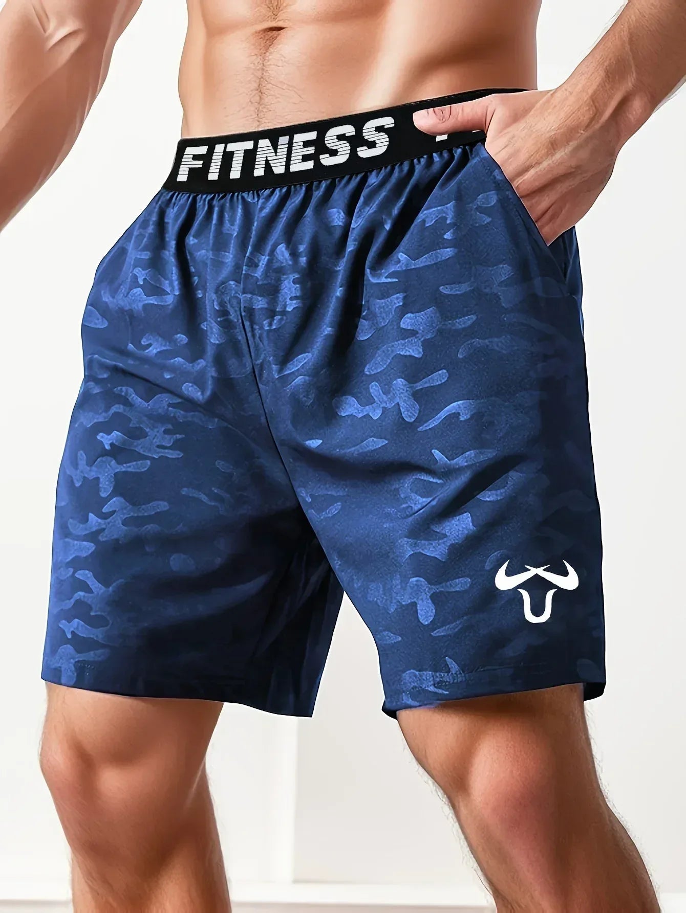 Blue camouflage fitness shorts with a visible brand logo on a white background
