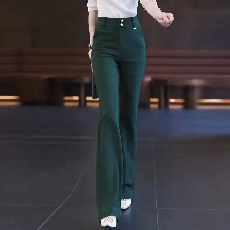 Person wearing dark green pants with a blurred background