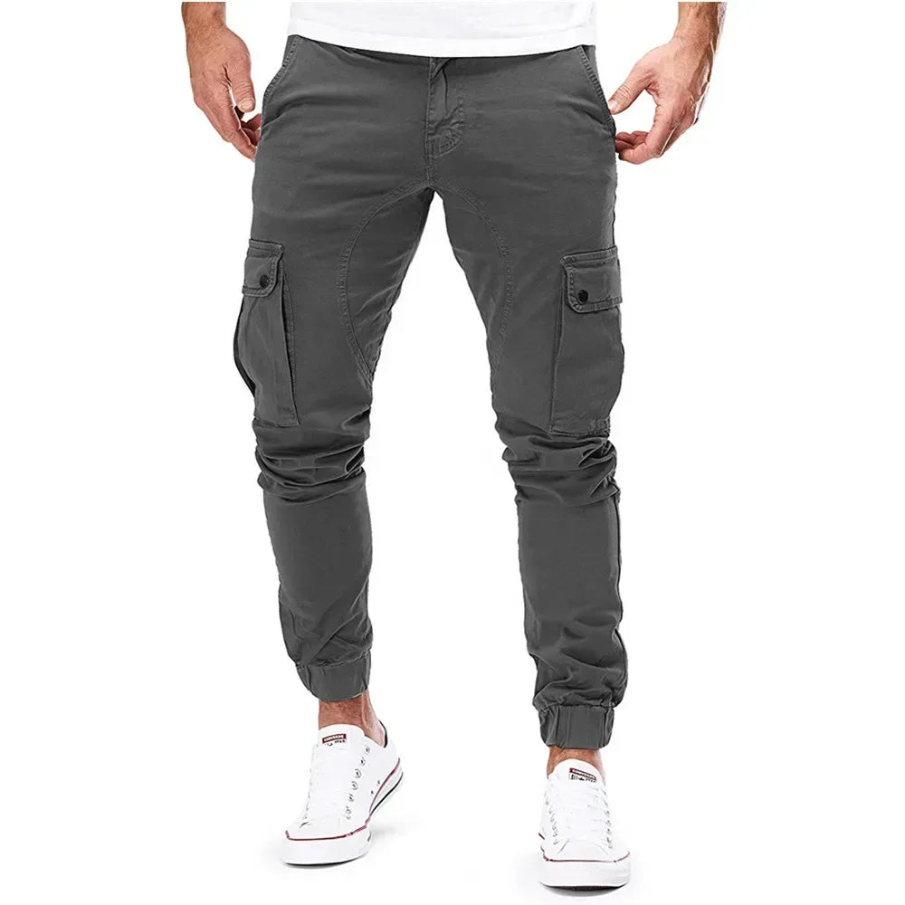 Person wearing gray cargo pants on a white background