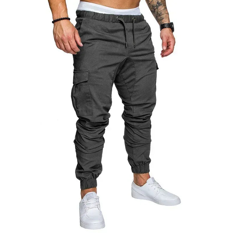 Gray cargo jogger pants worn by a person on a white background