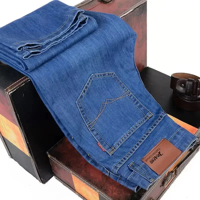 Blue jeans with a leather patch on a wooden surface