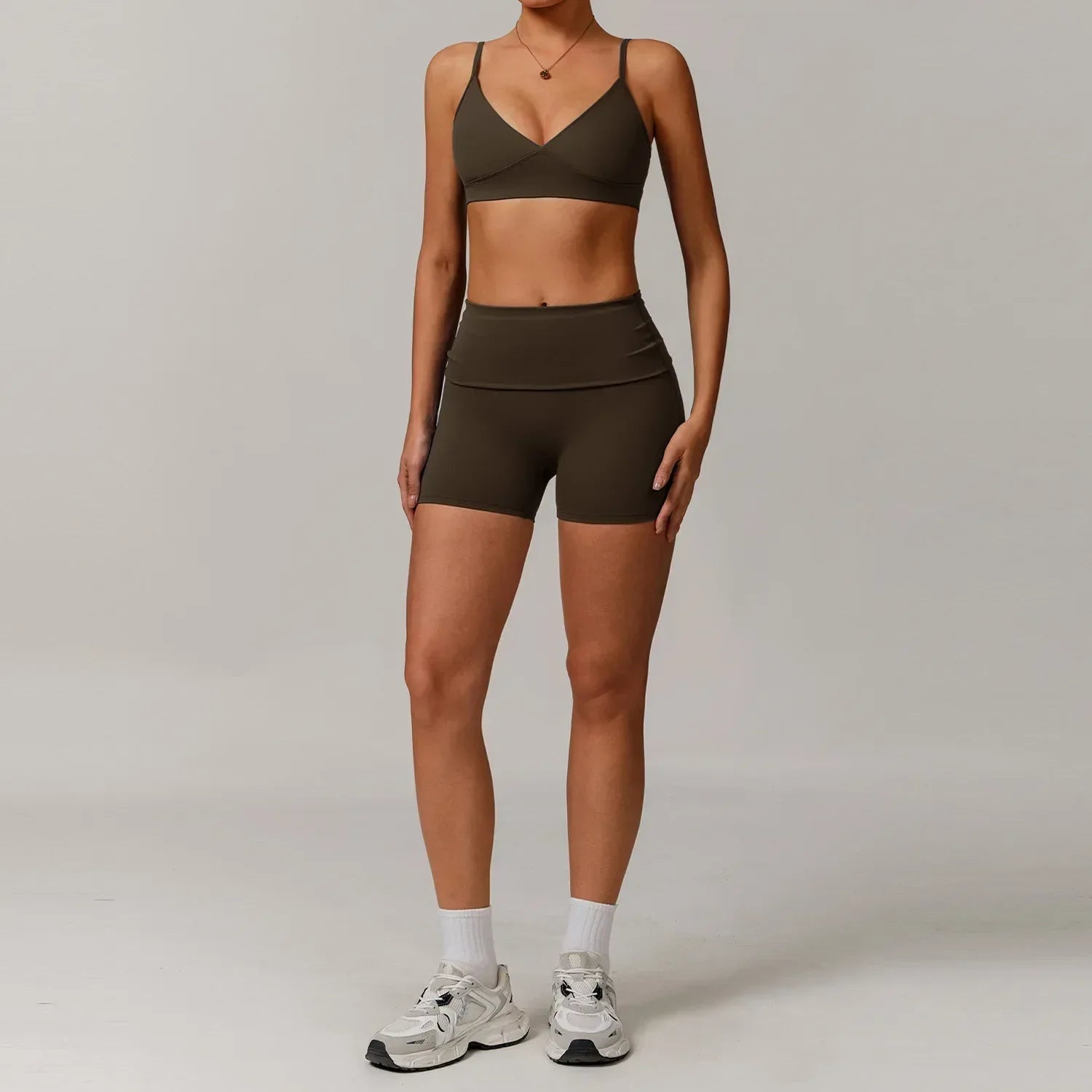 Woman wearing an espresso brown push up sports bra and high waisted scrunch butt shorts for a seamless booty lifting workout outfit - BetterPlace