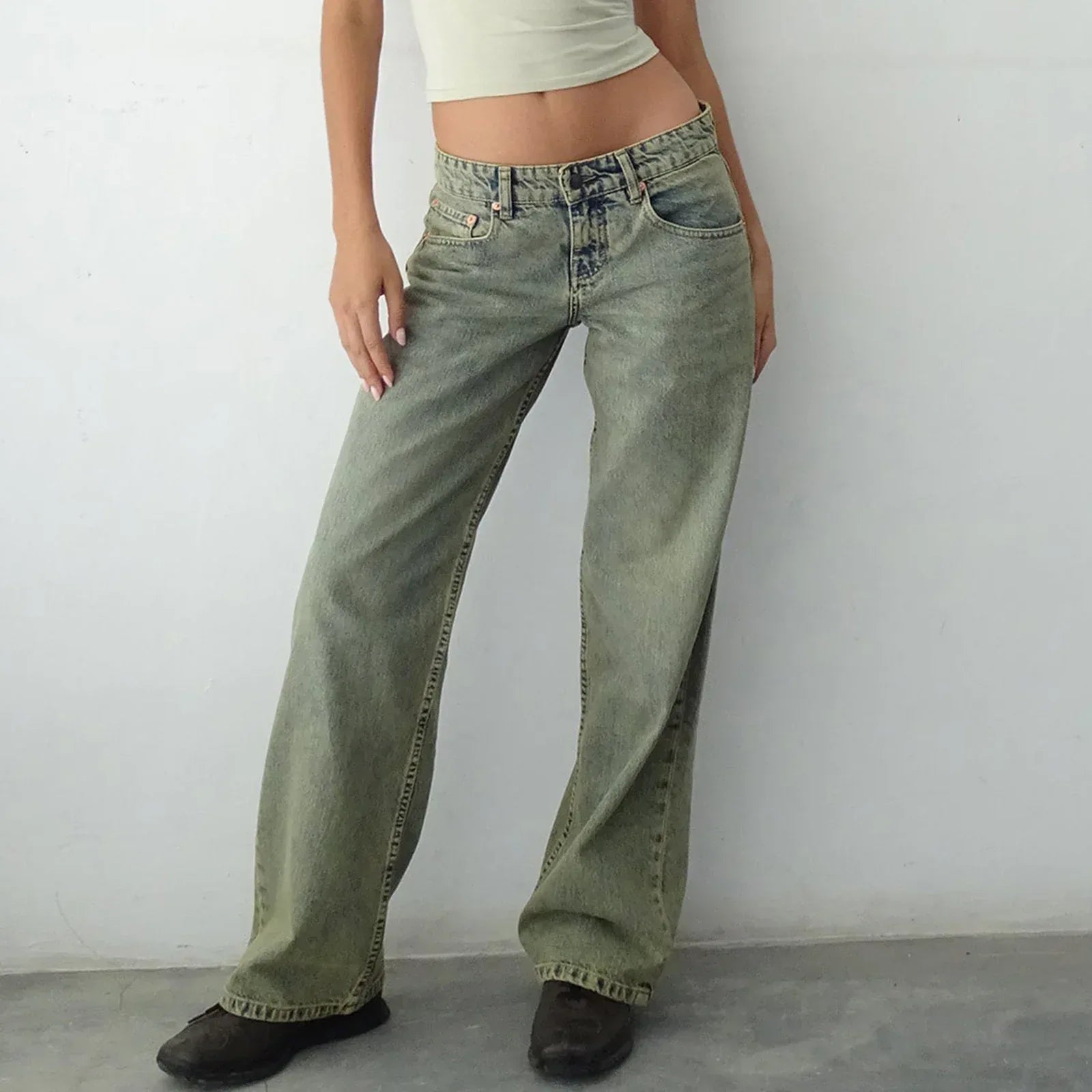 Person wearing high-waisted flared jeans against a plain background