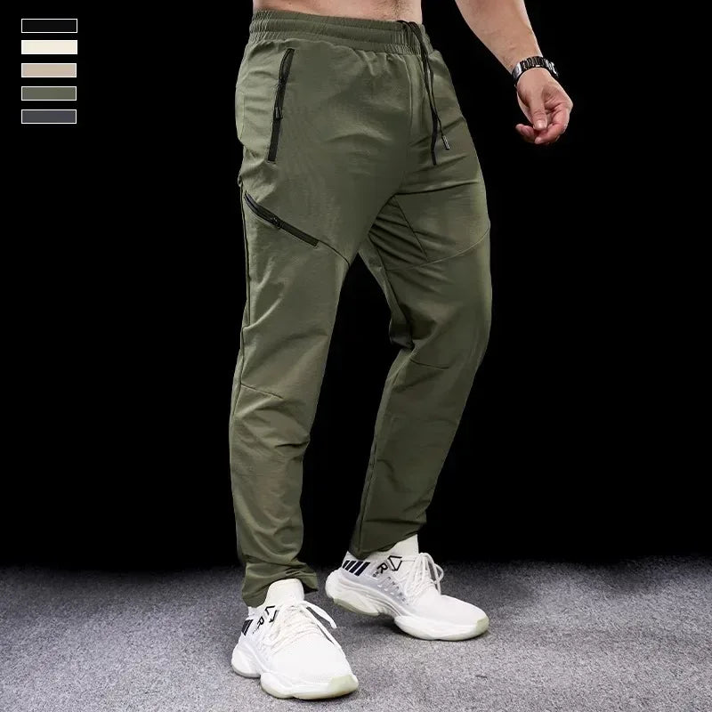 Person wearing green pants and white sneakers on a black background
