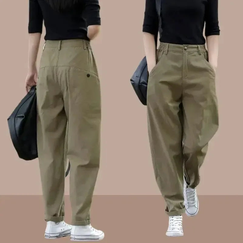 Person wearing beige pants with a black top against a beige background