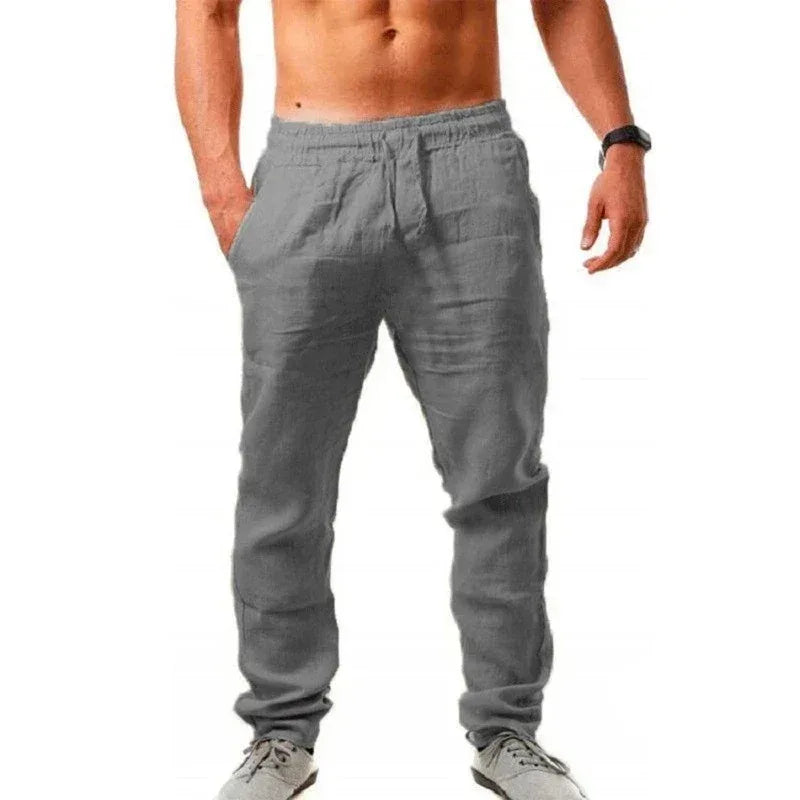 Gray jogger pants worn by a person on a white background