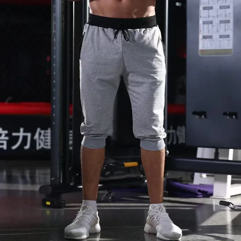 Person wearing gray sweatpants in a gym setting