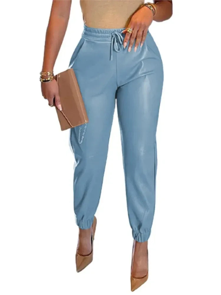 Light blue jogger pants worn by a person on a white background