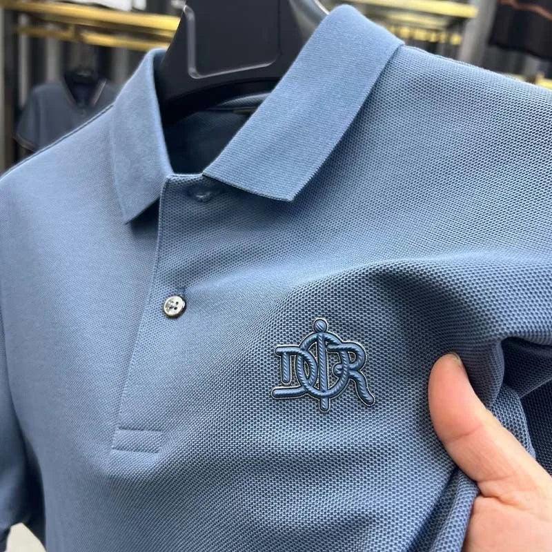 Blue polo shirt with a logo on a hanger