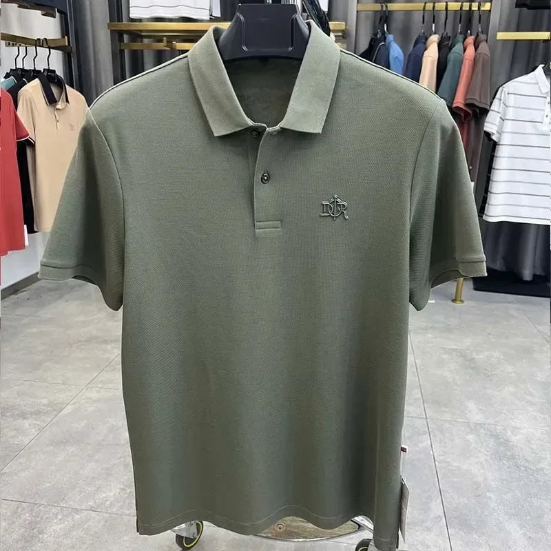 Green polo shirt with a logo on a hanger in a store setting