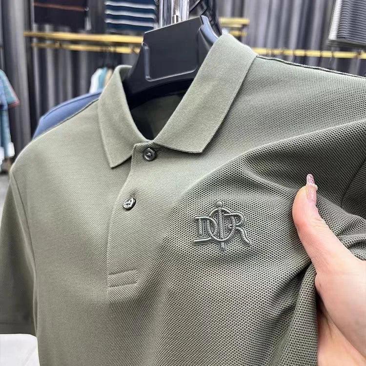 Green polo shirt with a logo on a hanger