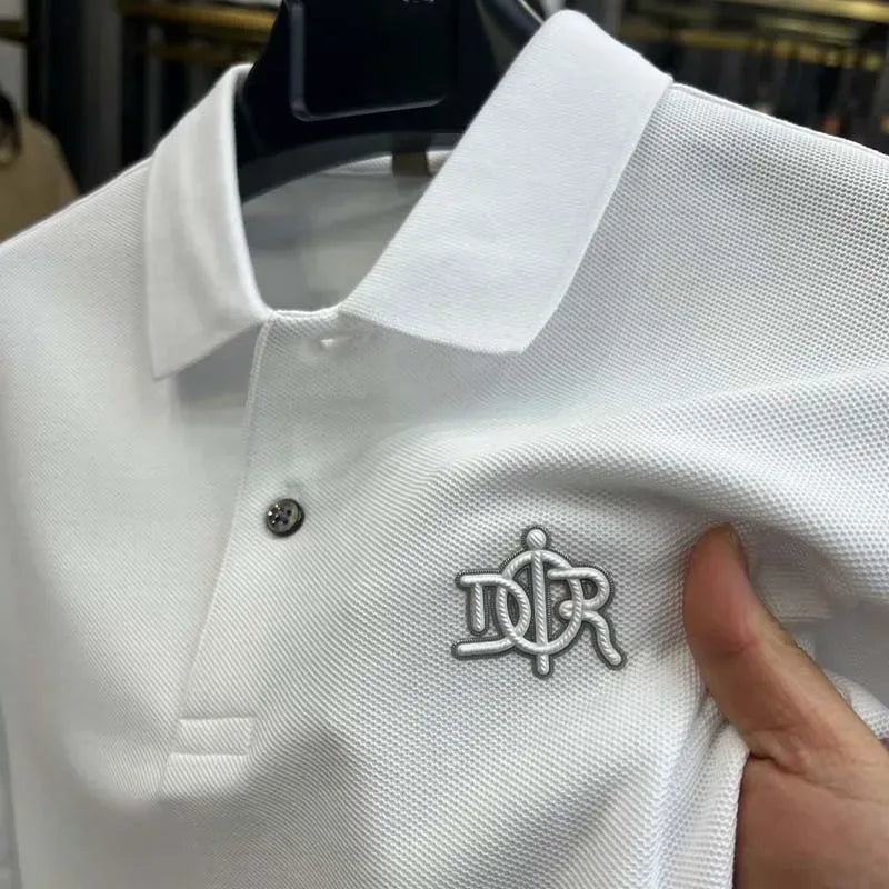 White polo shirt with a logo on a hanger