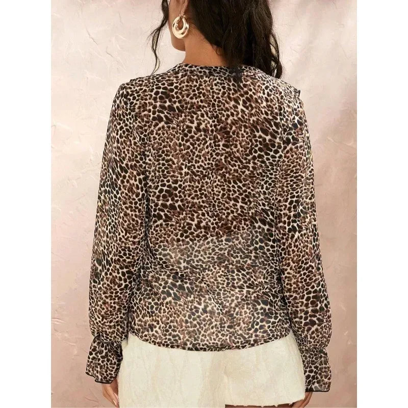 Leopard print blouse worn by a person on a plain background