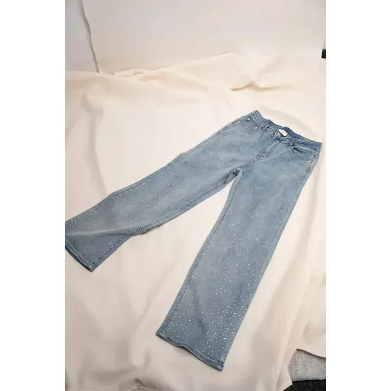 Light blue jeans on a white surface