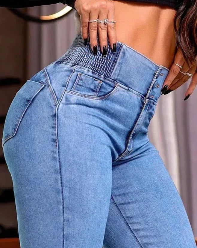Close-up of high-waisted blue jeans with a blurred background