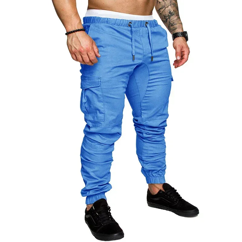 Blue cargo jogger pants worn by a person on a white background