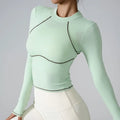 Light green long-sleeve top with black accents on a plain background