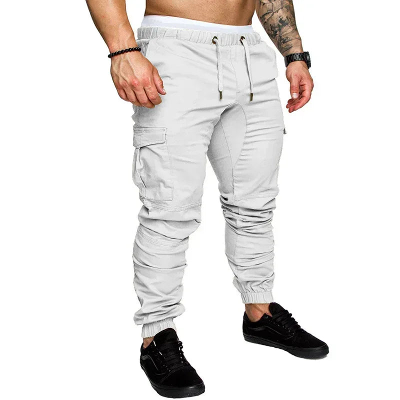White cargo jogger pants worn by a person on a white background