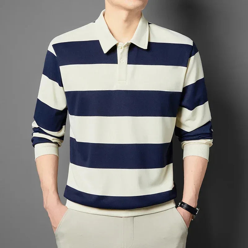 Person wearing a blue and white striped long-sleeve shirt against a gray background