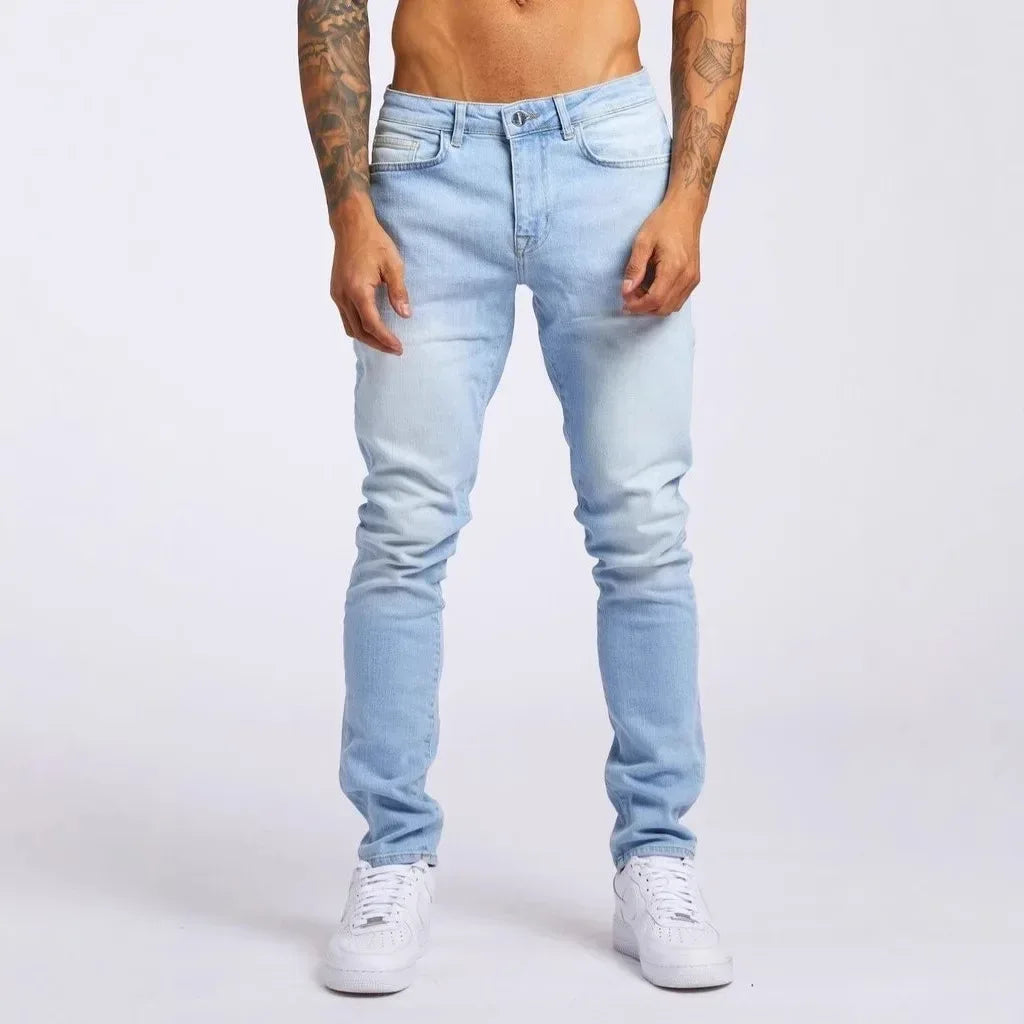 Light blue jeans worn by a person on a white background