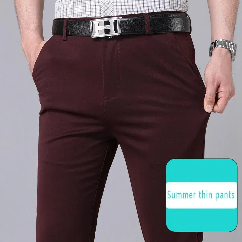 Maroon pants with a black belt on a gray background