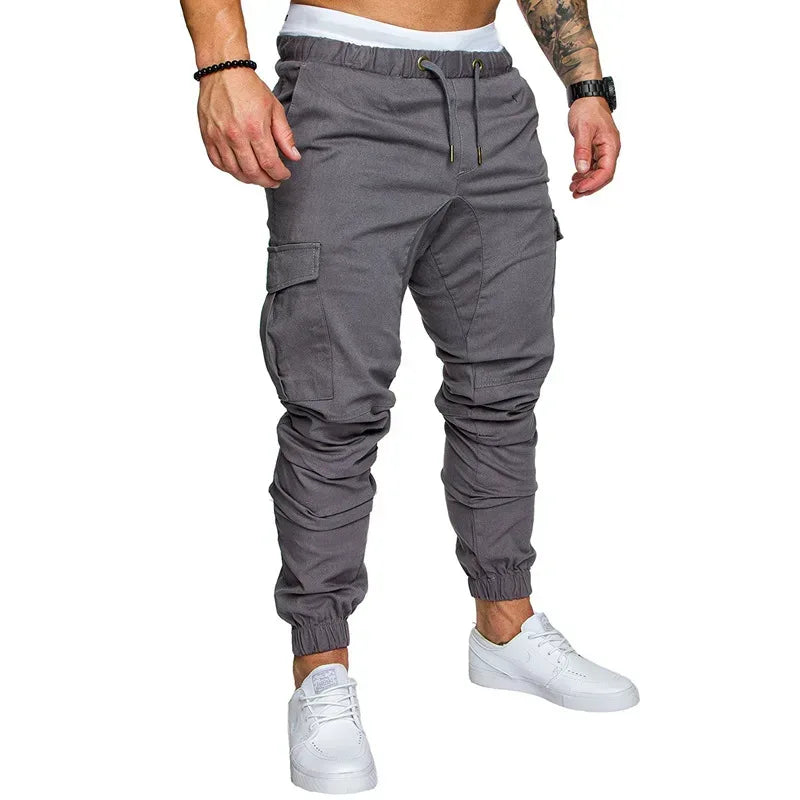 Gray cargo jogger pants worn by a person on a white background
