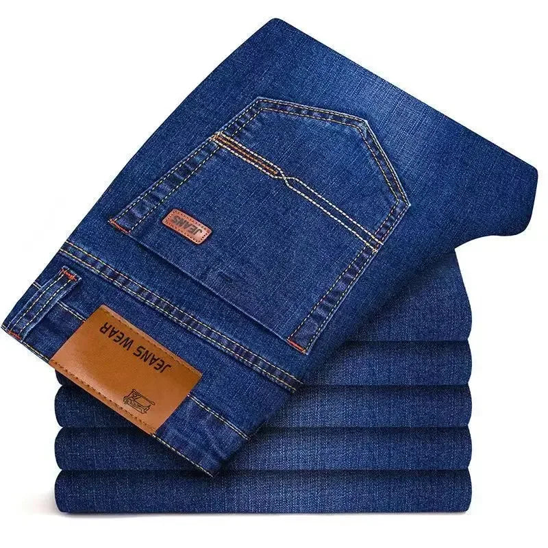 Stack of blue jeans with a visible brand label on a white background