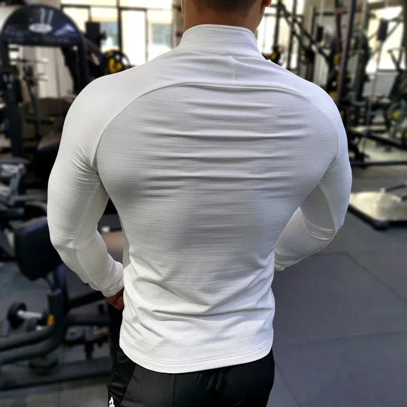 man flexing in white jacket Back view of a men’s windproof training jacket highlighting the athletic fit and reflective safety details - BetterPlace