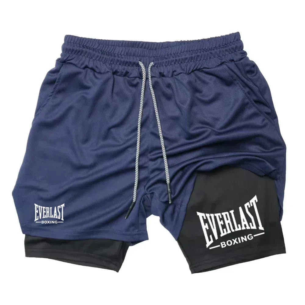 Blue athletic shorts with black patch featuring 'Everlast Boxing' on a white background
