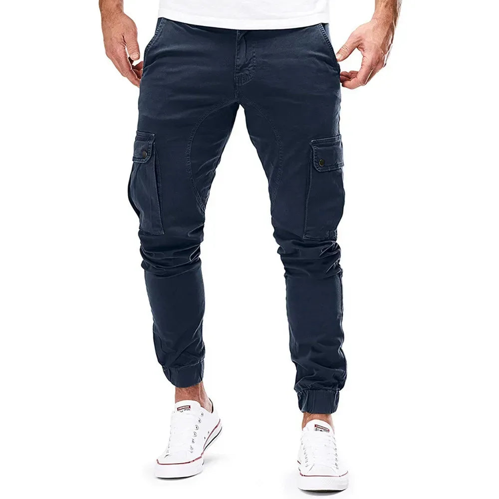 Navy cargo pants worn by a person on a white background