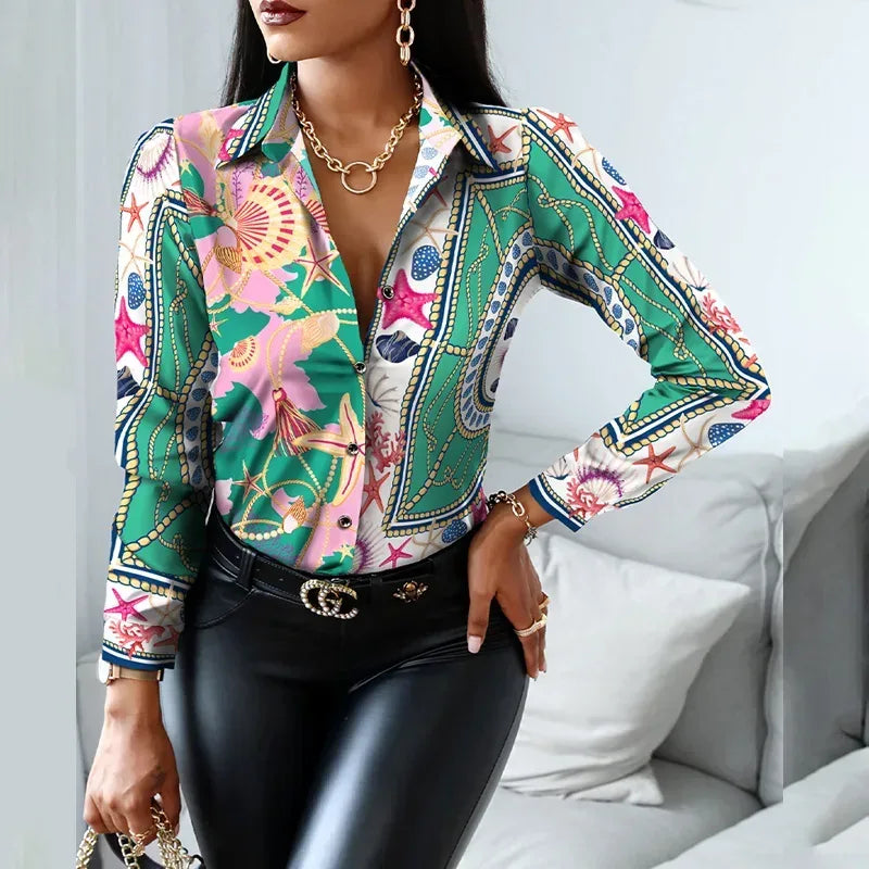 Woman wearing a colorful patterned blouse with black pants in a casual setting.
