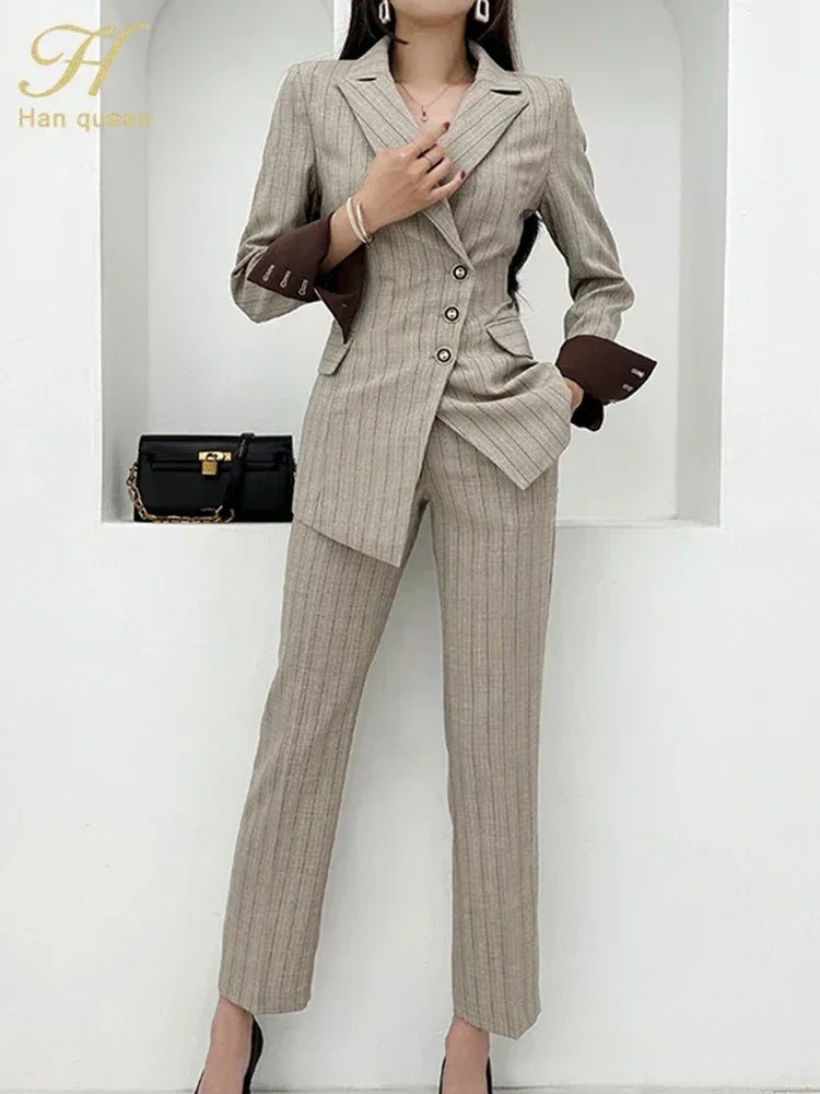 Woman wearing a gray pinstripe suit with a white background
