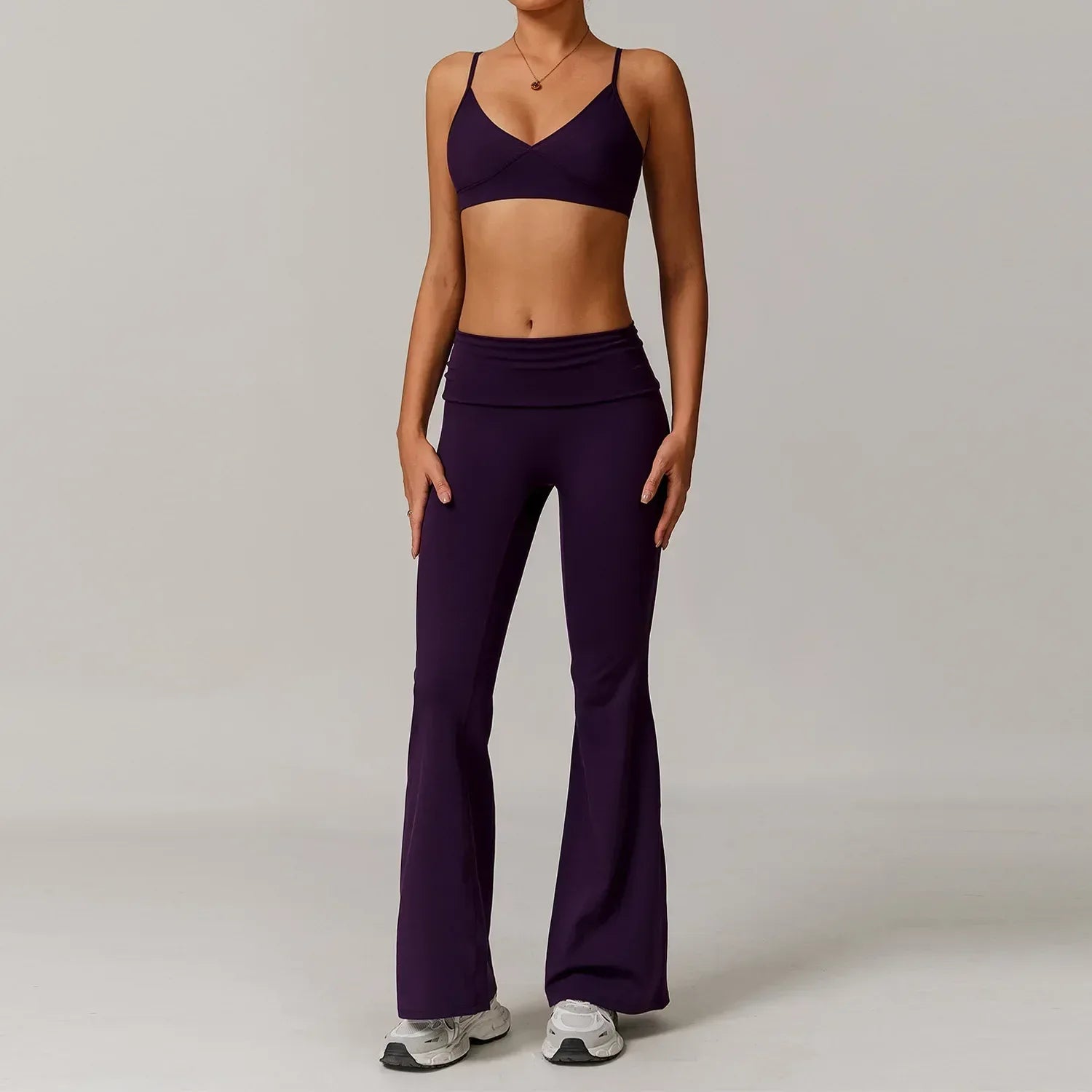 Two-piece purple yoga set with a supportive push up sports bra and high-waisted flared wide leg pants - BetterPlace