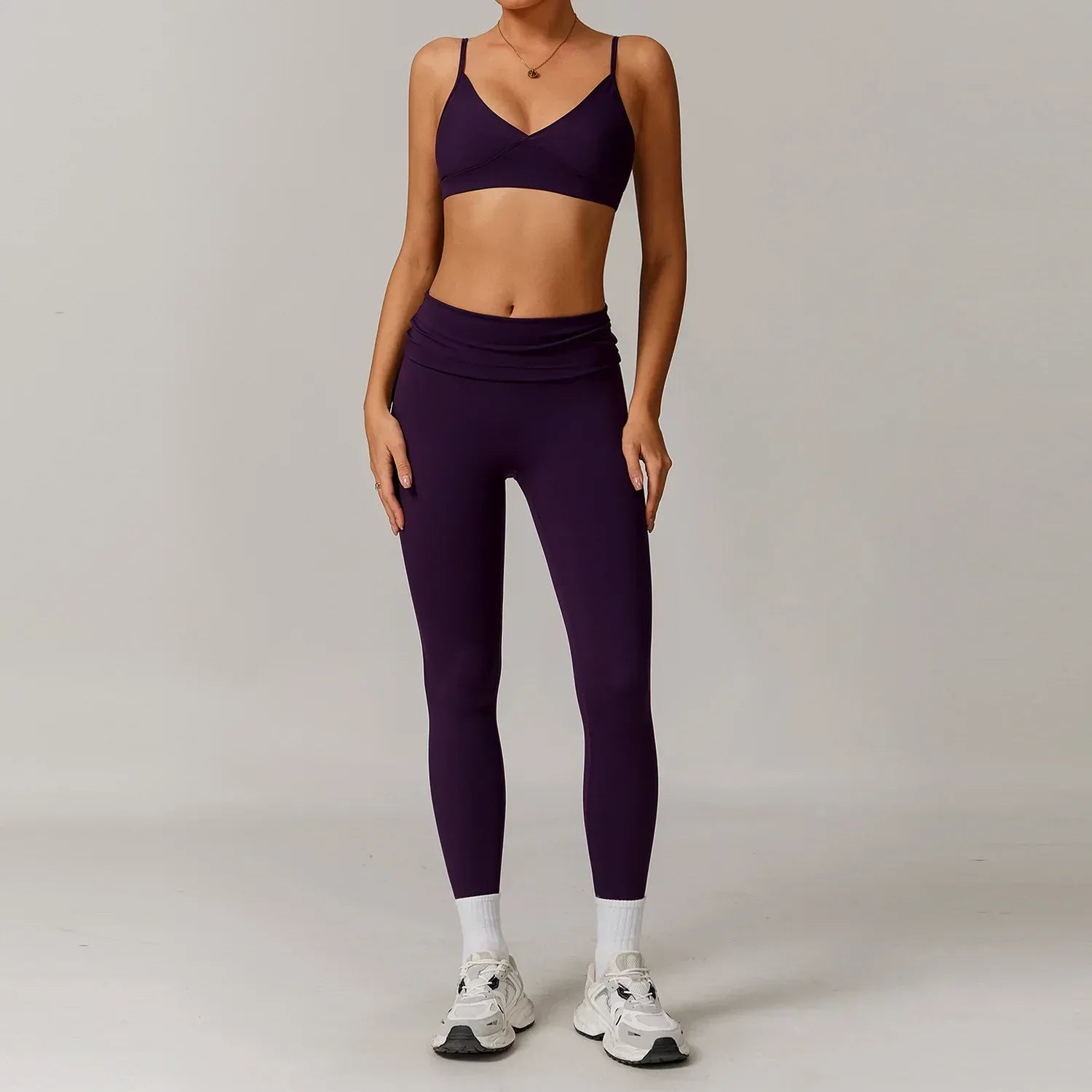 Woman wearing a purple push up sports bra and high waisted scrunch butt leggings for a seamless booty lifting workout outfit - BetterPlace