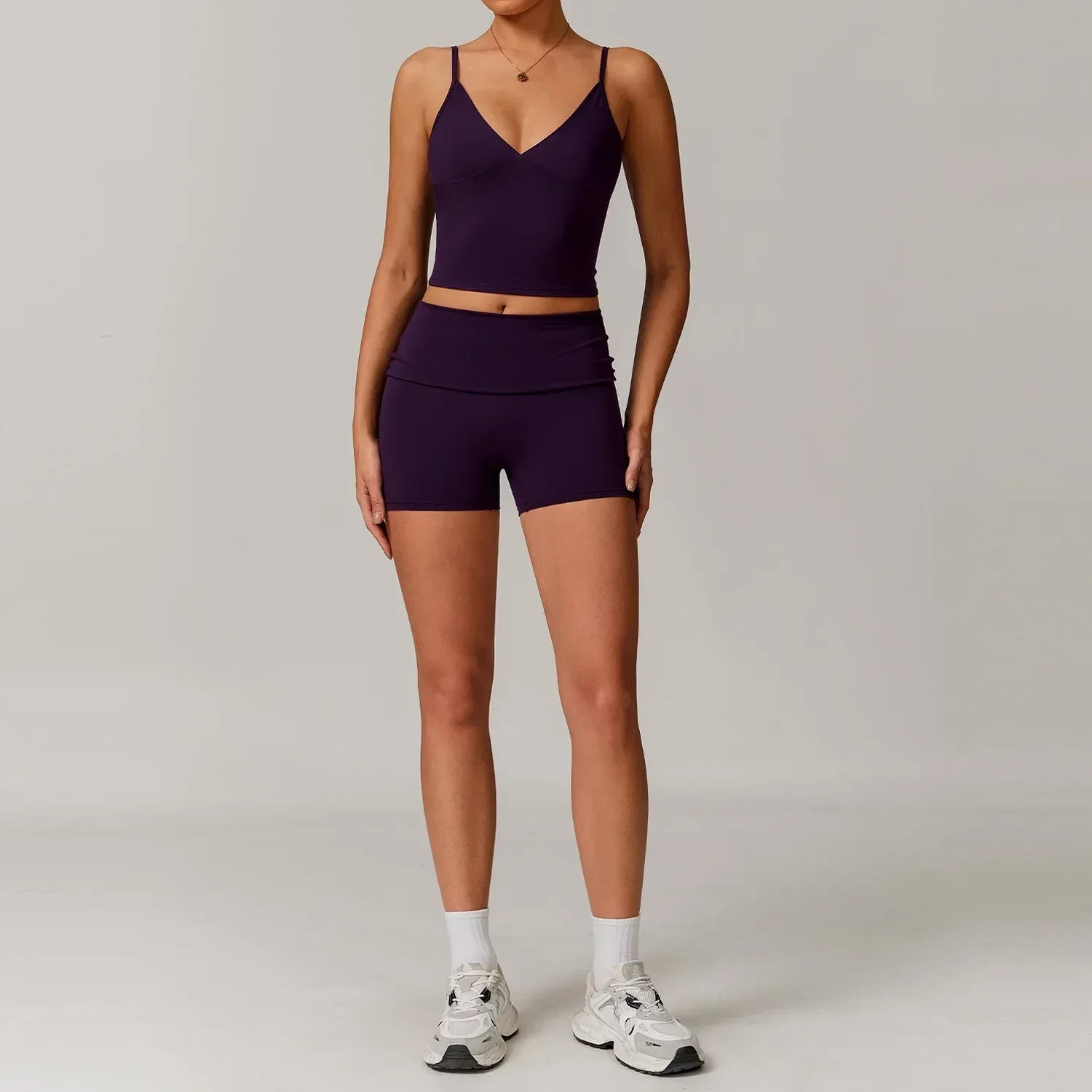 Woman wearing a lavender purple v-neck tank top and high waisted seamless workout shorts for a matching gym or yoga outfit set - BetterPlace
