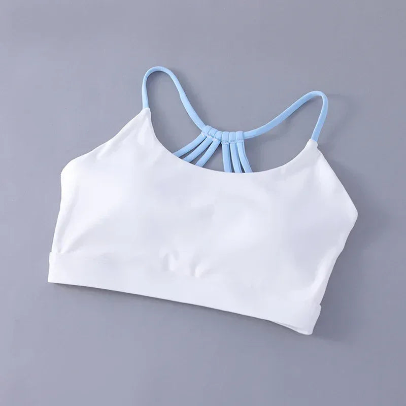White sports bra with light blue straps on a gray background