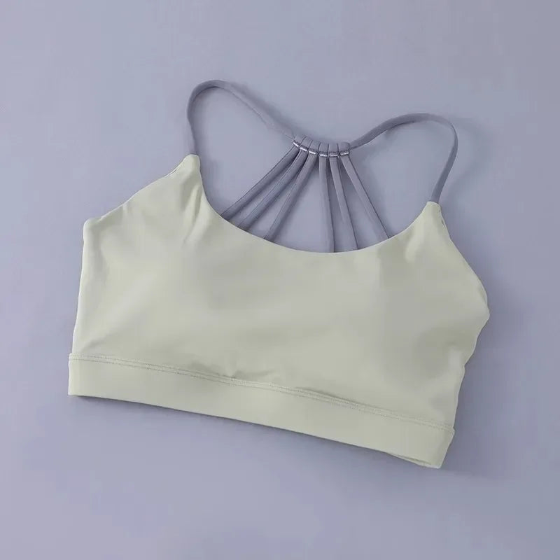 Light green sports bra on a gray background