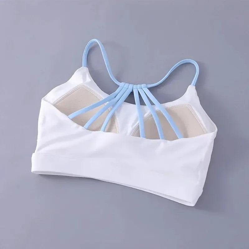 White sports bra with light blue straps on a gray background