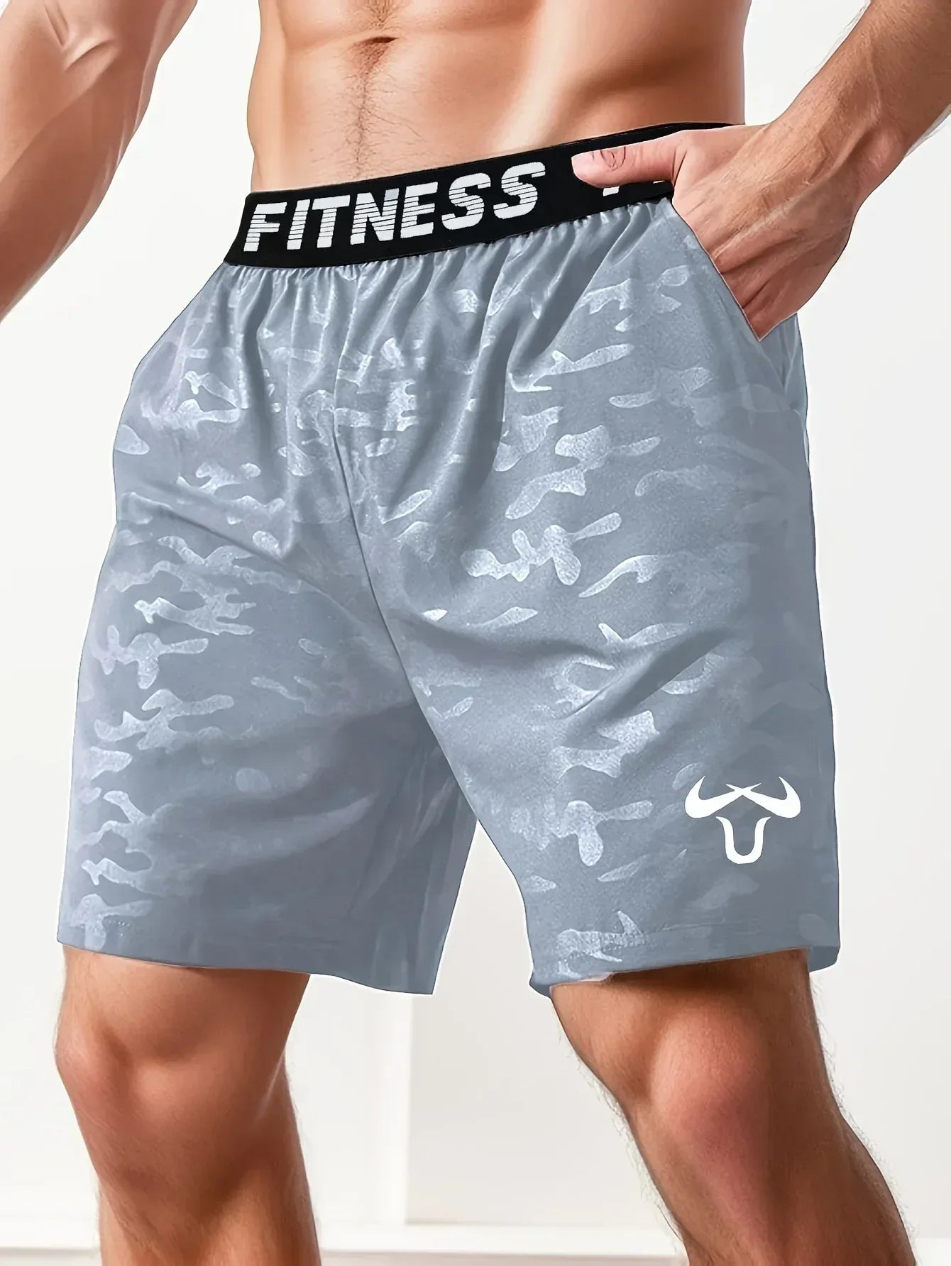 Light blue camouflage shorts with a black 'Fitness' waistband on a white background