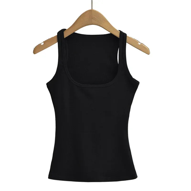 Black tank top on a wooden hanger against a white background