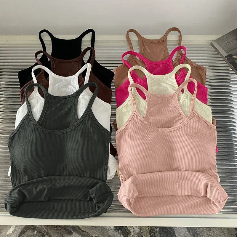 Set of women's tank tops in various colors on a white surface.