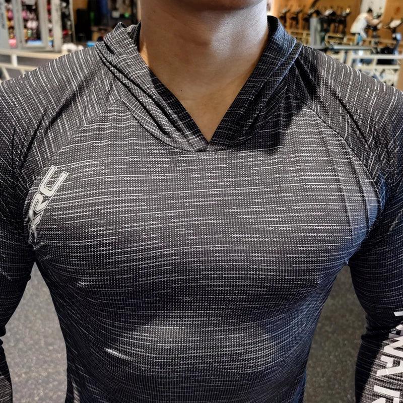 Person wearing a black and gray textured athletic shirt with a brand logo.