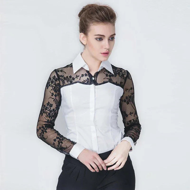 Woman wearing a white shirt with black lace sleeves against a plain background