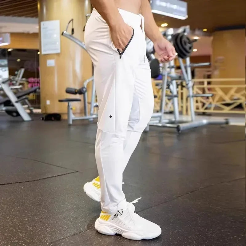 Person wearing white pants and sneakers in a gym setting