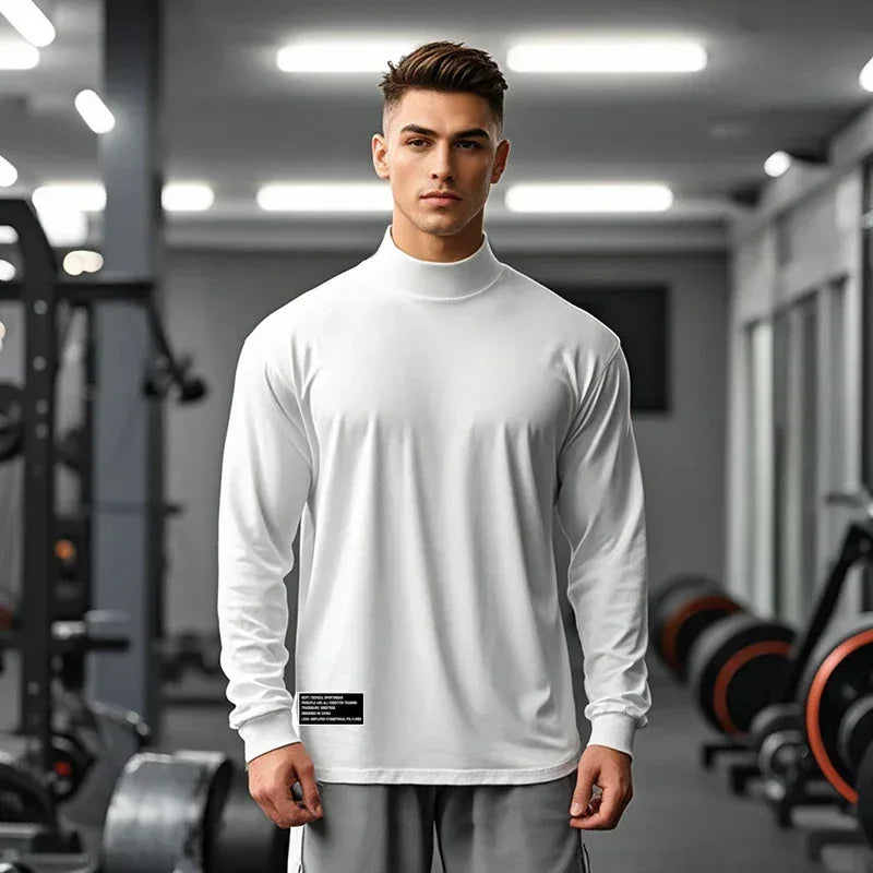 Man wearing a white long-sleeve shirt in a gym setting
