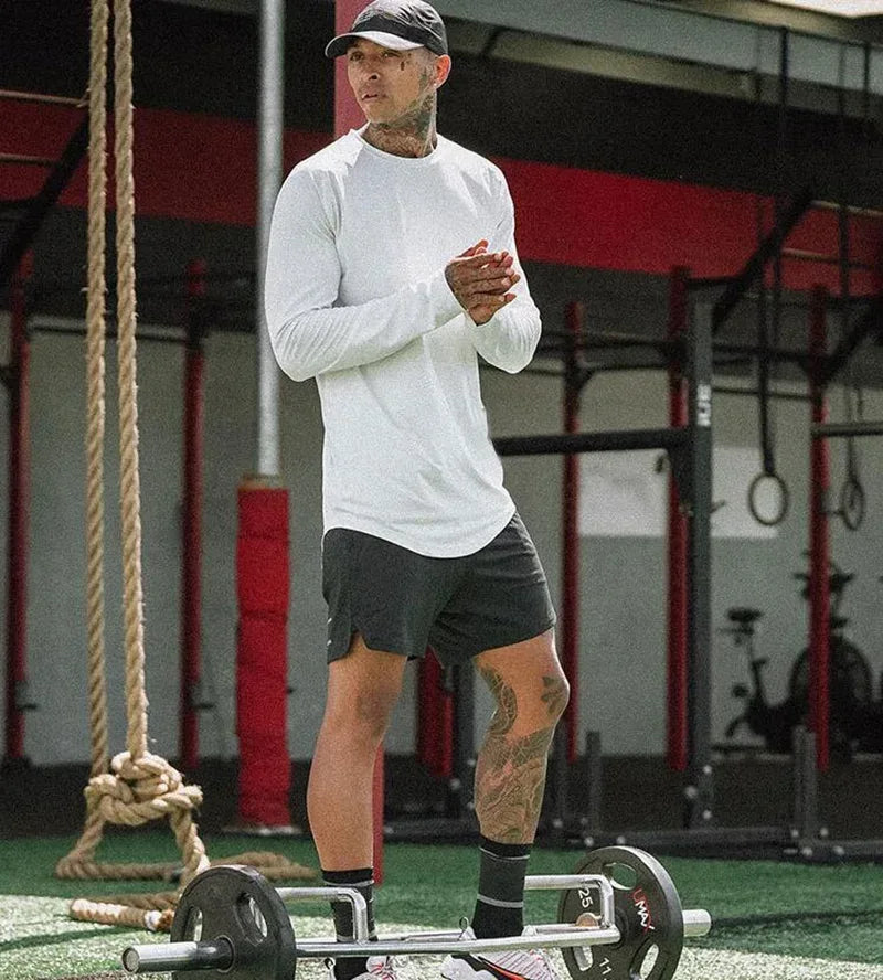Person standing on a balance board with weights in a gym setting