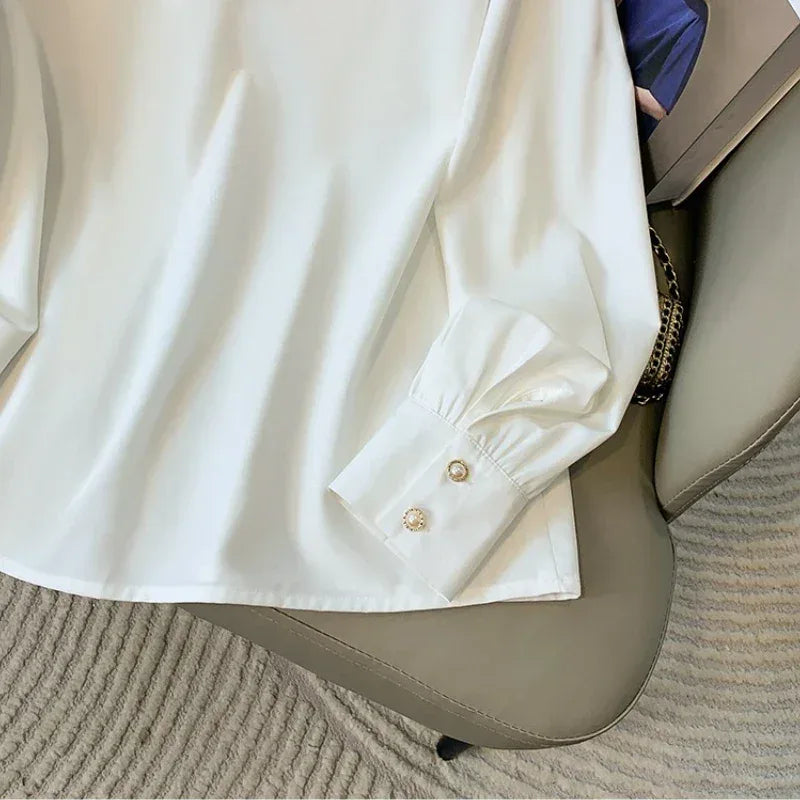 White shirt with rolled-up sleeves on a chair