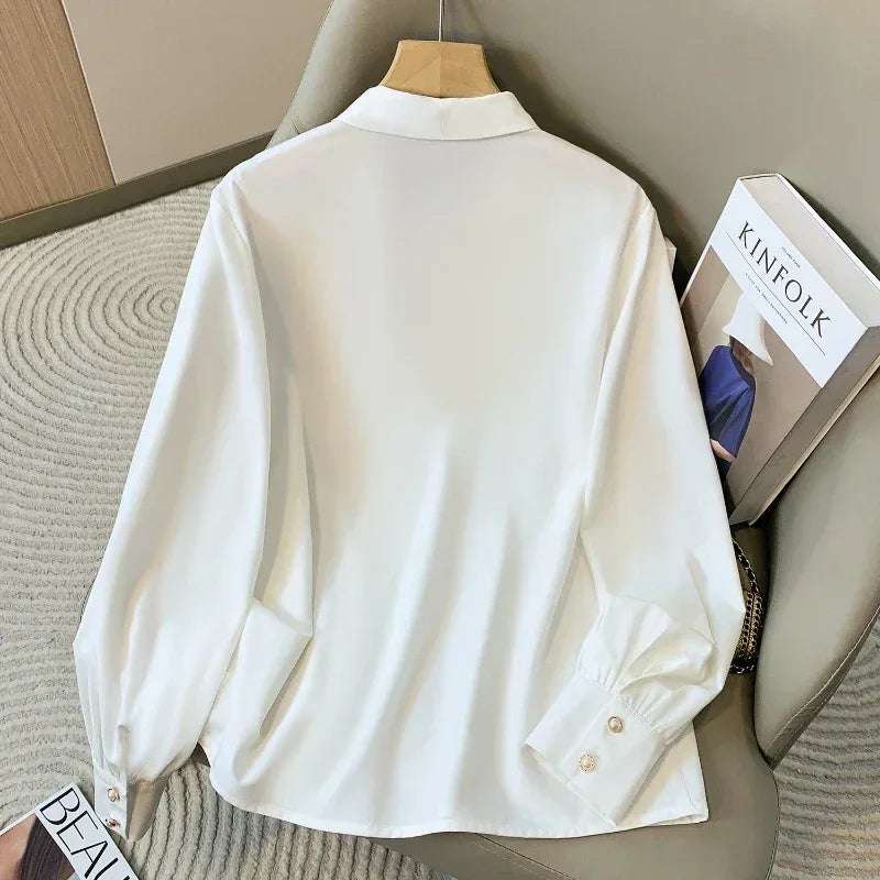 White shirt on a hanger with a book titled 'KINNFOLK' in the background.