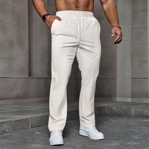 Person wearing white textured pants standing against a gray stone wall.