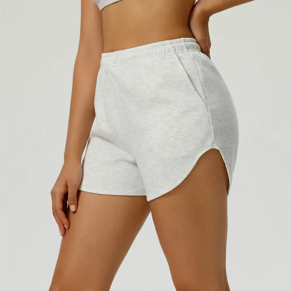 white Side profile of women’s elastic waist gym shorts showing the streamlined silhouette and reinforced stitching - BetterPlace